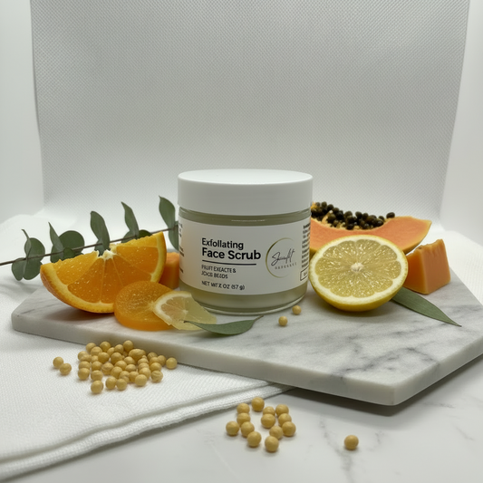 sunlit exfoliating face scrub sitting on a marble slab with citrus slices and greens around it